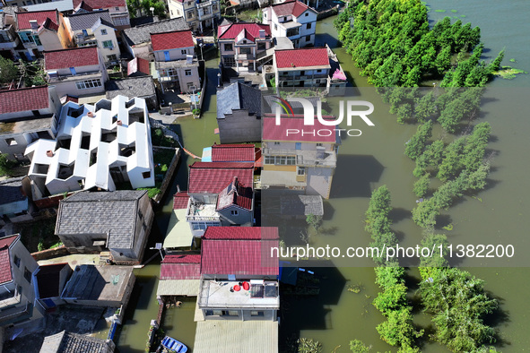 The water level of Shijiu Lake is rising after days of rainstorm, and some surrounding villages are flooding in Nanjing, China, on July 4, 2...