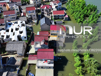 The water level of Shijiu Lake is rising after days of rainstorm, and some surrounding villages are flooding in Nanjing, China, on July 4, 2...