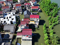 The water level of Shijiu Lake is rising after days of rainstorm, and some surrounding villages are flooding in Nanjing, China, on July 4, 2...