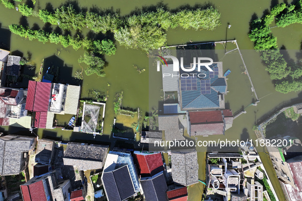 The water level of Shijiu Lake is rising after days of rainstorm, and some surrounding villages are flooding in Nanjing, China, on July 4, 2...