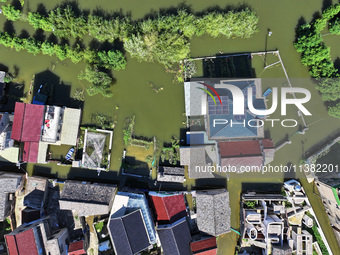 The water level of Shijiu Lake is rising after days of rainstorm, and some surrounding villages are flooding in Nanjing, China, on July 4, 2...