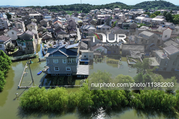 The water level of Shijiu Lake is rising after days of rainstorm, and some surrounding villages are flooding in Nanjing, China, on July 4, 2...