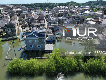 The water level of Shijiu Lake is rising after days of rainstorm, and some surrounding villages are flooding in Nanjing, China, on July 4, 2...