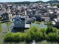 The water level of Shijiu Lake is rising after days of rainstorm, and some surrounding villages are flooding in Nanjing, China, on July 4, 2...