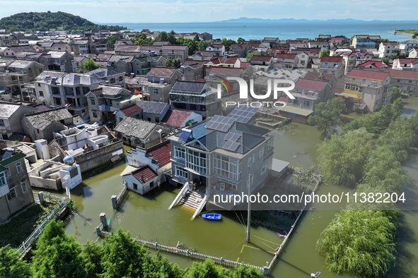 The water level of Shijiu Lake is rising after days of rainstorm, and some surrounding villages are flooding in Nanjing, China, on July 4, 2...