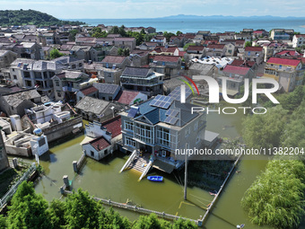 The water level of Shijiu Lake is rising after days of rainstorm, and some surrounding villages are flooding in Nanjing, China, on July 4, 2...