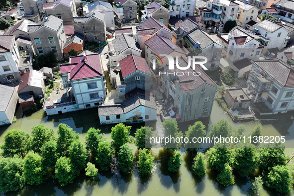 The water level of Shijiu Lake is rising after days of rainstorm, and some surrounding villages are flooding in Nanjing, China, on July 4, 2...