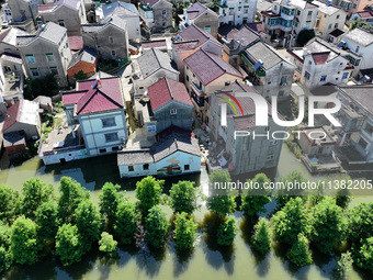 The water level of Shijiu Lake is rising after days of rainstorm, and some surrounding villages are flooding in Nanjing, China, on July 4, 2...