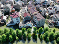 The water level of Shijiu Lake is rising after days of rainstorm, and some surrounding villages are flooding in Nanjing, China, on July 4, 2...