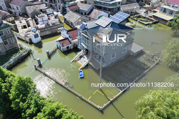 The water level of Shijiu Lake is rising after days of rainstorm, and some surrounding villages are flooding in Nanjing, China, on July 4, 2...