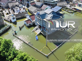 The water level of Shijiu Lake is rising after days of rainstorm, and some surrounding villages are flooding in Nanjing, China, on July 4, 2...