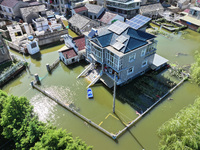 The water level of Shijiu Lake is rising after days of rainstorm, and some surrounding villages are flooding in Nanjing, China, on July 4, 2...