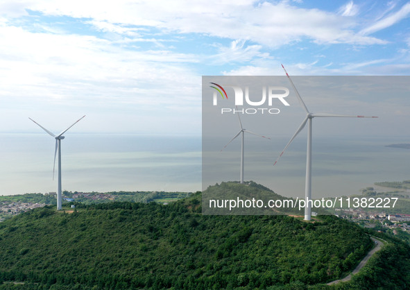 Wind turbines are operating at Chaohu Guanhu Wind Farm in Hualin town, Chaohu city, Anhui province, China, on July 3, 2024. 