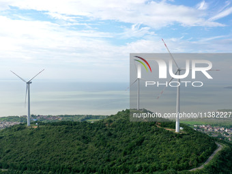 Wind turbines are operating at Chaohu Guanhu Wind Farm in Hualin town, Chaohu city, Anhui province, China, on July 3, 2024. (