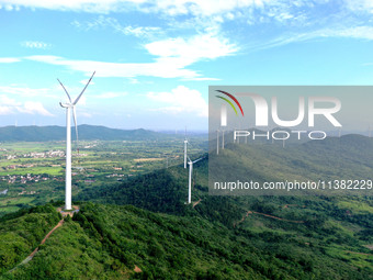 Wind turbines are operating at Chaohu Guanhu Wind Farm in Hualin town, Chaohu city, Anhui province, China, on July 3, 2024. (