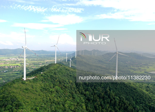 Wind turbines are operating at Chaohu Guanhu Wind Farm in Hualin town, Chaohu city, Anhui province, China, on July 3, 2024. 