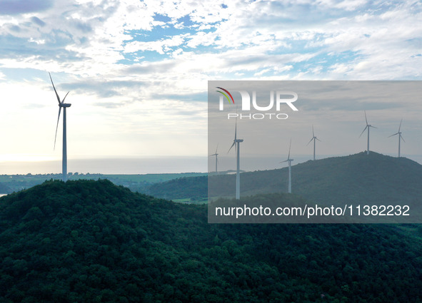 Wind turbines are operating at Chaohu Guanhu Wind Farm in Hualin town, Chaohu city, Anhui province, China, on July 3, 2024. 