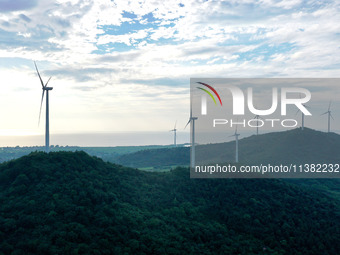 Wind turbines are operating at Chaohu Guanhu Wind Farm in Hualin town, Chaohu city, Anhui province, China, on July 3, 2024. (