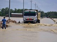 A truck is driving through a flooded road after heavy rainfall in Hojai District of Assam, India, on July 5, 2024. (