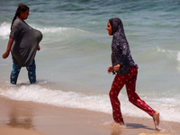 Displaced Palestinians are swimming next to a temporary camp in Khan Yunis, south of the Gaza Strip, on July 4, 2024, amid the ongoing confl...