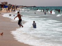 Displaced Palestinians are swimming next to a temporary camp in Khan Yunis, south of the Gaza Strip, on July 4, 2024, amid the ongoing confl...