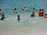 Displaced Palestinians are swimming next to a temporary camp in Khan Yunis, south of the Gaza Strip, on July 4, 2024, amid the ongoing confl...