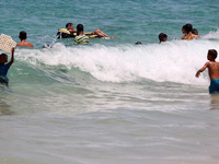 Displaced Palestinians are swimming next to a temporary camp in Khan Yunis, south of the Gaza Strip, on July 4, 2024, amid the ongoing confl...