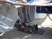 Displaced Palestinians are being seen next to a temporary camp in Khan Yunis, south of the Gaza Strip, on July 4, 2024, amid the ongoing con...