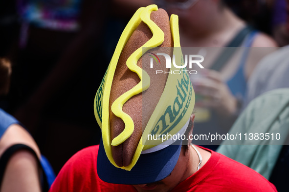 A person wears a hot dog hat during Nathan's Famous Hot Dogs Eating Contest which takes place annually at Coney Island on Independence Day i...