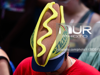 A person wears a hot dog hat during Nathan's Famous Hot Dogs Eating Contest which takes place annually at Coney Island on Independence Day i...