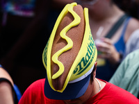 A person wears a hot dog hat during Nathan's Famous Hot Dogs Eating Contest which takes place annually at Coney Island on Independence Day i...