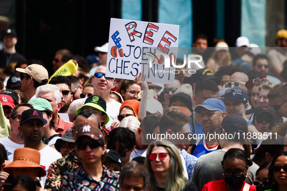 A person holds a banner standing for Joey Chestnut during Nathan's Famous Hot Dogs Eating Contest which takes place annually at Coney Island...