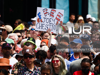 A person holds a banner standing for Joey Chestnut during Nathan's Famous Hot Dogs Eating Contest which takes place annually at Coney Island...