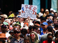 A person holds a banner standing for Joey Chestnut during Nathan's Famous Hot Dogs Eating Contest which takes place annually at Coney Island...