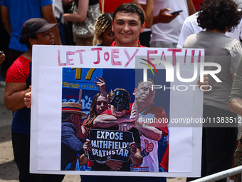 A person holds a banner standing for Joey Chestnut during Nathan's Famous Hot Dogs Eating Contest which takes place annually at Coney Island...