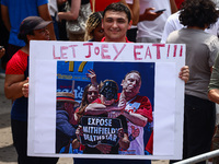 A person holds a banner standing for Joey Chestnut during Nathan's Famous Hot Dogs Eating Contest which takes place annually at Coney Island...