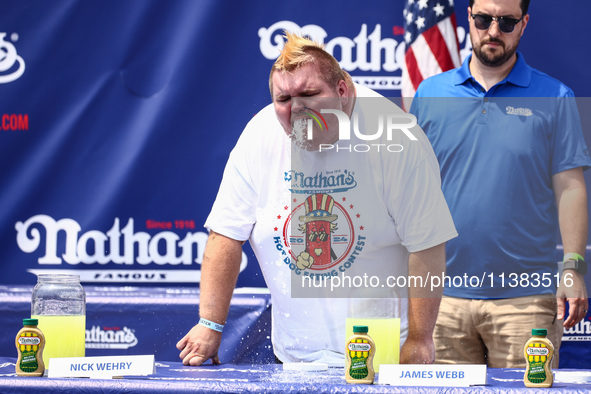 A contestant throws up after attending lemonade drinking contest during Nathan's Famous Hot Dogs Eating Contest which takes place annually a...