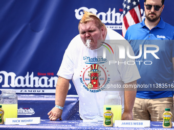 A contestant throws up after attending lemonade drinking contest during Nathan's Famous Hot Dogs Eating Contest which takes place annually a...