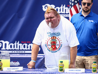 A contestant throws up after attending lemonade drinking contest during Nathan's Famous Hot Dogs Eating Contest which takes place annually a...