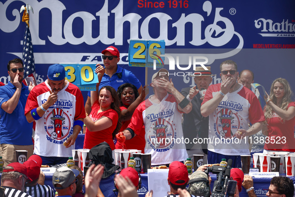 Patrick Bertoletti and other contestants attend the men's title during Nathan's Famous Hot Dogs Eating Contest which takes place annually at...