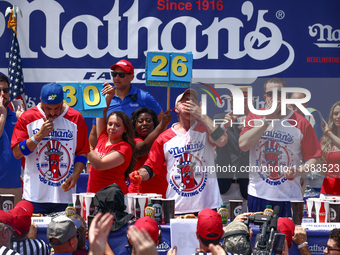 Patrick Bertoletti and other contestants attend the men's title during Nathan's Famous Hot Dogs Eating Contest which takes place annually at...