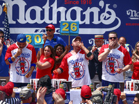 Patrick Bertoletti and other contestants attend the men's title during Nathan's Famous Hot Dogs Eating Contest which takes place annually at...