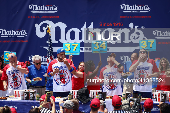 Patrick Bertoletti and other contestants attend the men's title during Nathan's Famous Hot Dogs Eating Contest which takes place annually at...