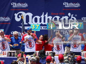 Patrick Bertoletti and other contestants attend the men's title during Nathan's Famous Hot Dogs Eating Contest which takes place annually at...