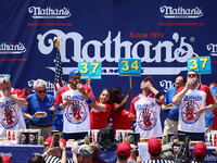 Patrick Bertoletti and other contestants attend the men's title during Nathan's Famous Hot Dogs Eating Contest which takes place annually at...