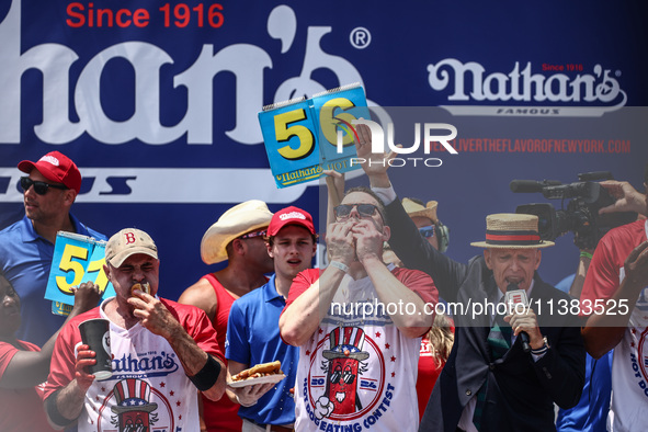 Patrick Bertoletti and other contestants attend the men's title during Nathan's Famous Hot Dogs Eating Contest which takes place annually at...