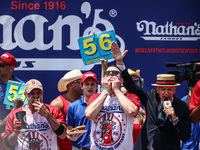 Patrick Bertoletti and other contestants attend the men's title during Nathan's Famous Hot Dogs Eating Contest which takes place annually at...