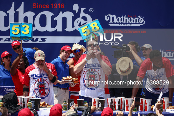 Patrick Bertoletti and other contestants attend the men's title during Nathan's Famous Hot Dogs Eating Contest which takes place annually at...