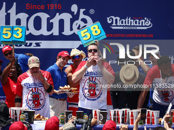 Patrick Bertoletti and other contestants attend the men's title during Nathan's Famous Hot Dogs Eating Contest which takes place annually at...