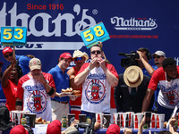 Patrick Bertoletti and other contestants attend the men's title during Nathan's Famous Hot Dogs Eating Contest which takes place annually at...